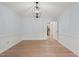 Empty dining room featuring fresh paint, hardwood floors and modern light fixture at 8000 Old Deer Trl, Raleigh, NC 27615