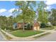 Aerial view of a well-maintained home showcasing its brick facade, two-car garage, and beautiful lawn at 8000 Old Deer Trl, Raleigh, NC 27615