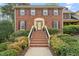 Brick home's front exterior featuring landscaped yard and steps leading up to the front door at 8000 Old Deer Trl, Raleigh, NC 27615