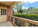 Inviting covered front porch with brick accents, black railing, and a hanging flower basket adding charm at 8000 Old Deer Trl, Raleigh, NC 27615