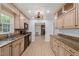 Eat in kitchen featuring natural wood cabinets, granite counters and stainless appliances at 8000 Old Deer Trl, Raleigh, NC 27615