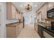 Bright kitchen with natural wood cabinets and stainless steel appliances at 8000 Old Deer Trl, Raleigh, NC 27615