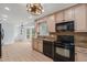 Kitchen featuring wood cabinets, granite countertops, and stainless steel appliances at 8000 Old Deer Trl, Raleigh, NC 27615