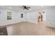 Large living room featuring hardwood floors, fresh paint, and views to the outside at 8000 Old Deer Trl, Raleigh, NC 27615