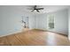 Bright living room featuring hardwood floors, a ceiling fan and stairs to the second floor at 8000 Old Deer Trl, Raleigh, NC 27615