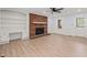Cozy living room with a red brick fireplace, built-in shelving, and neutral walls at 8000 Old Deer Trl, Raleigh, NC 27615
