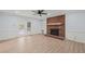Spacious living room featuring a fireplace, built-ins and double doors to the deck at 8000 Old Deer Trl, Raleigh, NC 27615