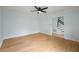 Empty living room featuring hardwood floors, light blue walls and stairs to the second floor at 8000 Old Deer Trl, Raleigh, NC 27615