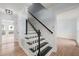 Charming staircase featuring hardwood floors and stairs with white risers at 8000 Old Deer Trl, Raleigh, NC 27615