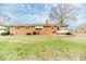 Brick home with a large backyard, patio, and sunroom, perfect for outdoor enjoyment at 808 N Franklin Dr, Sanford, NC 27330