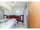 Bathroom with red tile, white fixtures, and a mirrored vanity for classic appeal at 808 N Franklin Dr, Sanford, NC 27330