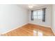 A well-lit bedroom with polished hardwood floors, neutral walls, and double hung windows at 808 N Franklin Dr, Sanford, NC 27330