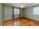 Bright bedroom with hardwood floors, neutral wall paint, and natural light from windows at 808 N Franklin Dr, Sanford, NC 27330