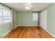 Inviting bedroom with hardwood floors, a ceiling fan, natural light and a convenient closet system at 808 N Franklin Dr, Sanford, NC 27330