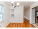 Dining space showcasing built-in shelving, hardwood floors, and a view into the next room at 808 N Franklin Dr, Sanford, NC 27330