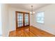 Dining room with hardwood floors, stylish lighting, and access to a sunroom at 808 N Franklin Dr, Sanford, NC 27330