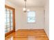 Bright dining area featuring hardwood floors, a chandelier, and adjacent built-in shelving at 808 N Franklin Dr, Sanford, NC 27330