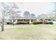 Charming red brick ranch home with a well-manicured front yard and mature landscaping at 808 N Franklin Dr, Sanford, NC 27330