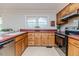 Bright kitchen featuring wooden cabinets, a window above the sink, and modern appliances at 808 N Franklin Dr, Sanford, NC 27330