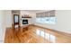 Spacious living room featuring gleaming hardwood floors, a fireplace, and large windows at 808 N Franklin Dr, Sanford, NC 27330