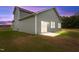 A spacious backyard featuring a concrete patio and sliding glass door, ideal for relaxation at 825 Kenyon Spring Dr, Zebulon, NC 27597