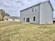View of the back exterior of a two-story home with a sodded lawn at 829 Kenyon Spring Dr, Zebulon, NC 27597
