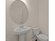 A well-lit powder room featuring a sleek pedestal sink and modern fixtures at 829 Kenyon Spring Dr, Zebulon, NC 27597