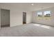 A bedroom with two windows and doorways to the bathroom and hallway at 829 Kenyon Spring Dr, Zebulon, NC 27597
