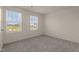 This bedroom has carpet, and two windows that provide natural light at 829 Kenyon Spring Dr, Zebulon, NC 27597