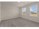 A bright bedroom with two large windows and plush carpeting at 829 Kenyon Spring Dr, Zebulon, NC 27597