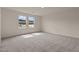 A bright bedroom with two large windows and plush carpeting at 829 Kenyon Spring Dr, Zebulon, NC 27597