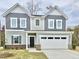 Charming two-story home with a two-car garage and attractive gray and white siding at 829 Kenyon Spring Dr, Zebulon, NC 27597