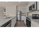 Modern kitchen with granite countertops, stainless steel appliances, and ample cabinet space at 829 Kenyon Spring Dr, Zebulon, NC 27597