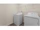 Functional laundry area with modern white appliances and wire shelving at 829 Kenyon Spring Dr, Zebulon, NC 27597