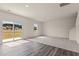 Bright living room with plush carpeting, a large window, and access to the backyard at 829 Kenyon Spring Dr, Zebulon, NC 27597