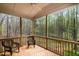 Screened in back porch with two rocking chairs overlooking wooded area at 8418 Wheatstone Ln, Raleigh, NC 27613