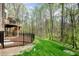 Landscaped backyard with fenced-in patio area and mature trees, creating a private outdoor space at 8418 Wheatstone Ln, Raleigh, NC 27613