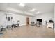Finished basement with exercise equipment, entertainment center, and computer desk at 8418 Wheatstone Ln, Raleigh, NC 27613