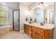 Bathroom featuring a large vanity with double sinks, a tub, and tiled floors at 8418 Wheatstone Ln, Raleigh, NC 27613