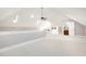 Large bonus room with vaulted ceiling, white carpet, and ping pong table at 8418 Wheatstone Ln, Raleigh, NC 27613