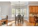 Sunlit breakfast nook features a stylish pendant light and views of the backyard at 8418 Wheatstone Ln, Raleigh, NC 27613