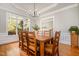 Elegant dining room features a large window and classic chandelier, perfect for Gathering gatherings at 8418 Wheatstone Ln, Raleigh, NC 27613
