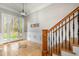 Foyer featuring tile floors, staircase and a modern light fixture, creating a welcoming entrance at 8418 Wheatstone Ln, Raleigh, NC 27613