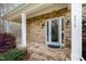 Inviting front porch with stone accents and a stylish entrance door, creating a warm and welcoming first impression at 8418 Wheatstone Ln, Raleigh, NC 27613