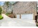 This home features a stone-accented lower level with two-car garage and a large driveway at 8418 Wheatstone Ln, Raleigh, NC 27613