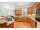 Spacious kitchen features granite countertops, wood cabinets, stainless steel appliances and hardwood flooring at 8418 Wheatstone Ln, Raleigh, NC 27613