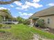 Lush backyard featuring a deck, green lawn, and mature trees for added privacy at 8437 Little Woody Ct, Zebulon, NC 27597