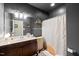 This stylish bathroom features a wooden vanity, white marbled countertop, and modern fixtures at 8437 Little Woody Ct, Zebulon, NC 27597