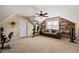 Cozy bonus room under the eaves featuring built-in bookshelves, ceiling fan, and multi-gym at 8437 Little Woody Ct, Zebulon, NC 27597