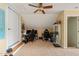 The bonus room has an attic ceiling, carpeted floor, and a ceiling fan with integrated light at 8437 Little Woody Ct, Zebulon, NC 27597